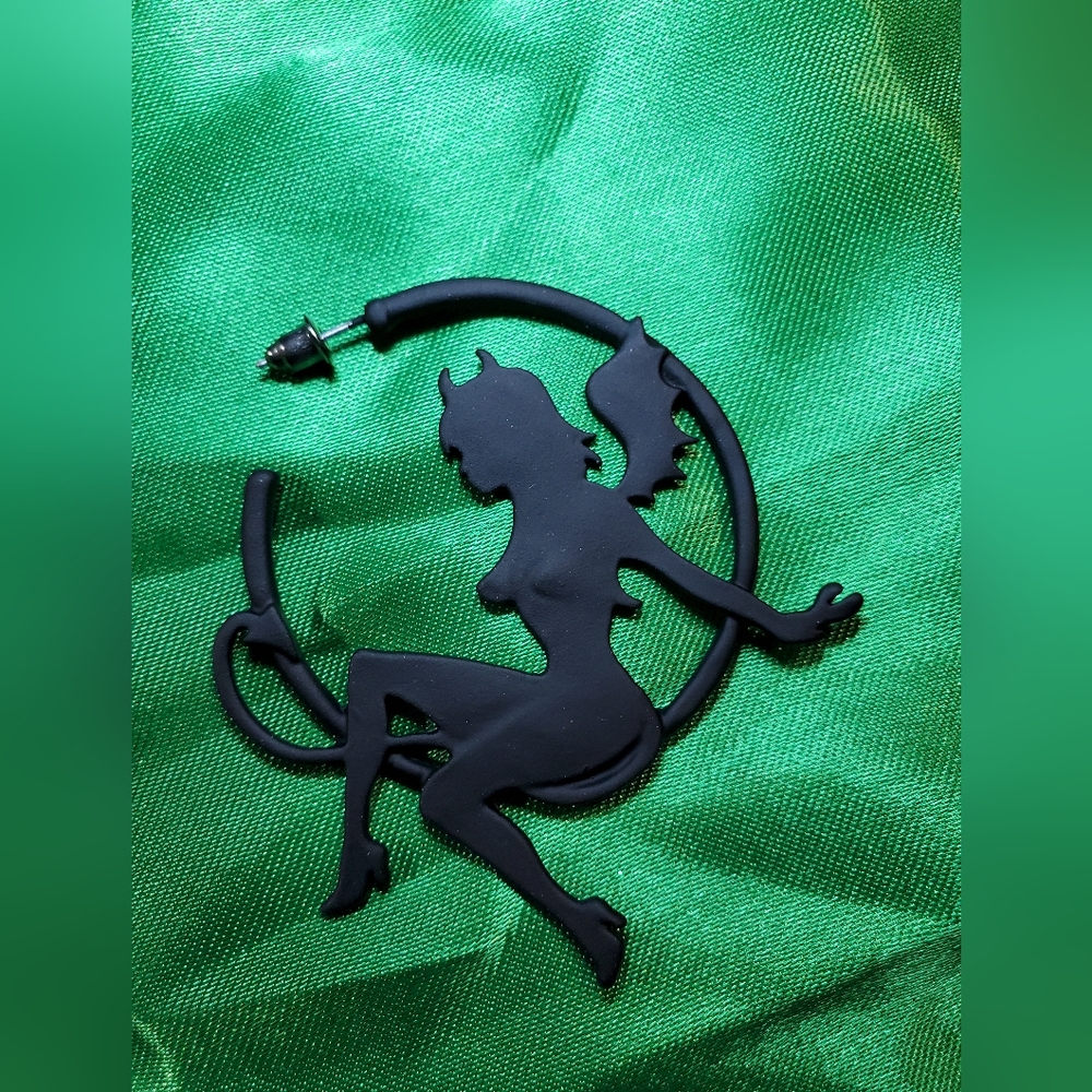 Vintage Retro style Iron She Devil sitting in a metal hoop.